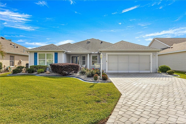 single story home featuring a front yard and a garage