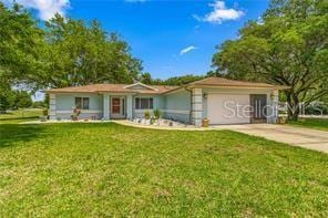 single story home with a front lawn and a garage