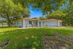 ranch-style home with a front lawn