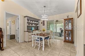 tiled dining space with lofted ceiling