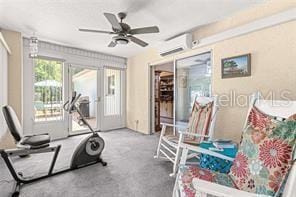 workout area featuring carpet flooring, a wall mounted AC, ceiling fan, and french doors