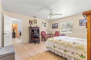 bedroom with light tile patterned floors and ceiling fan