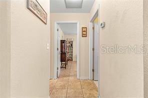 corridor featuring light tile patterned floors