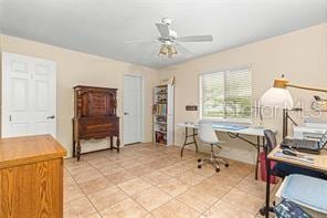 tiled office featuring ceiling fan