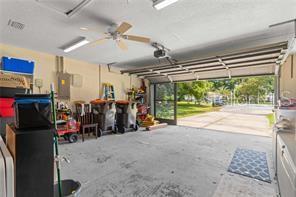 garage with ceiling fan and electric panel