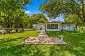 rear view of house with a lawn