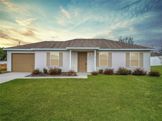 single story home featuring a garage and a yard