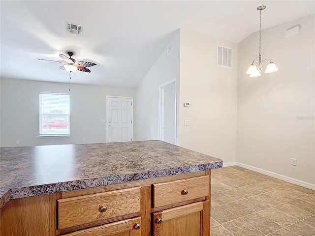 kitchen with lofted ceiling, decorative light fixtures, and ceiling fan with notable chandelier