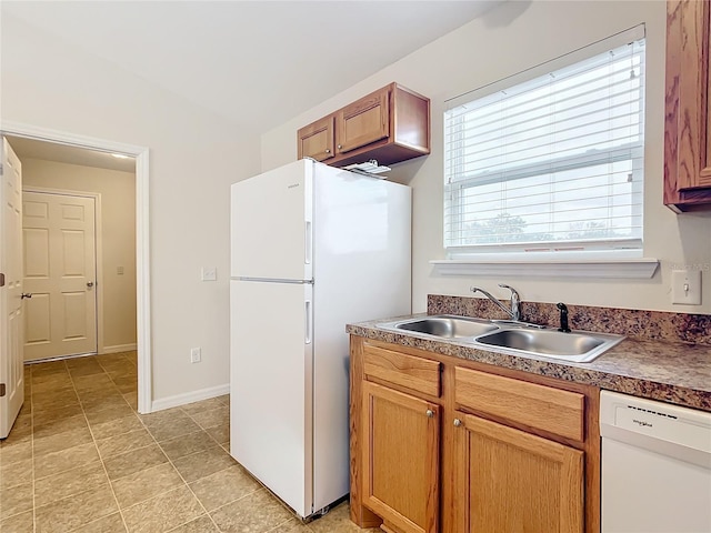 kitchen featuring white appliances and sink