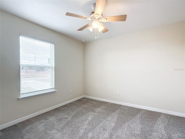 carpeted spare room with ceiling fan