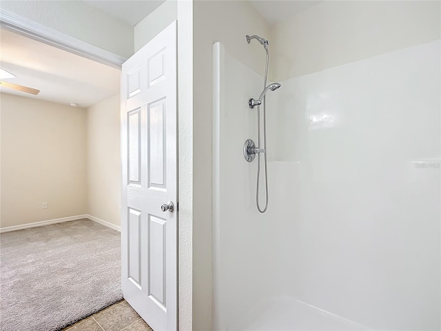 bathroom with tile patterned floors, ceiling fan, and walk in shower