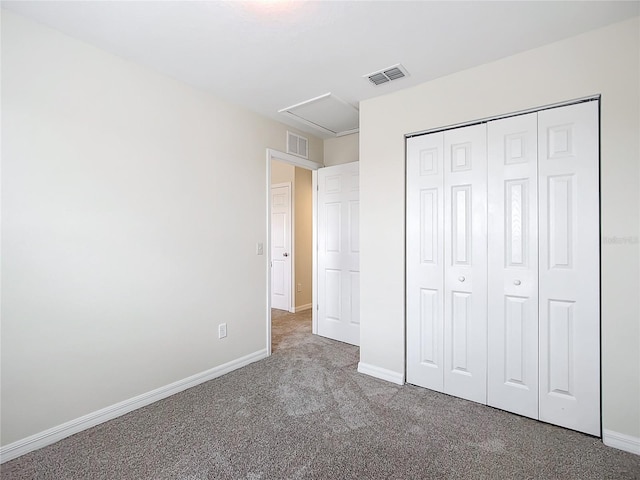 unfurnished bedroom featuring carpet flooring and a closet