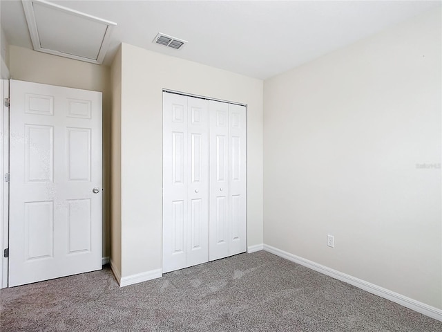 unfurnished bedroom with carpet flooring and a closet