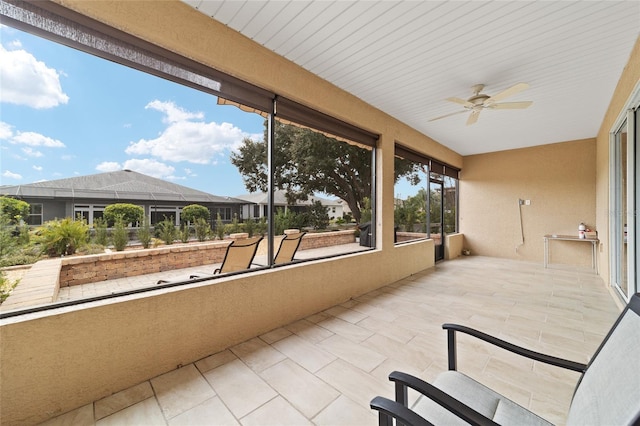 sunroom featuring ceiling fan