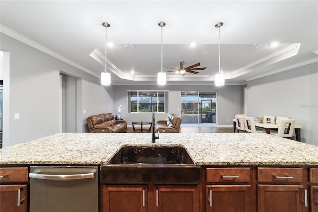 kitchen featuring a raised ceiling, ceiling fan, and ornamental molding