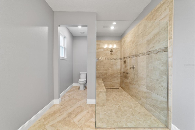 bathroom with toilet and tiled shower