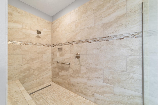 bathroom with a tile shower