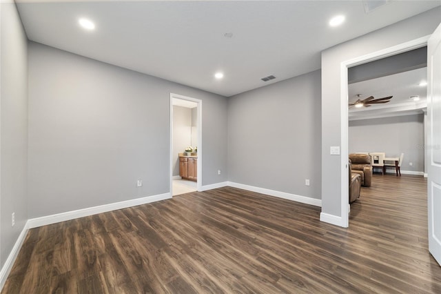 spare room featuring ceiling fan and dark wood-type flooring