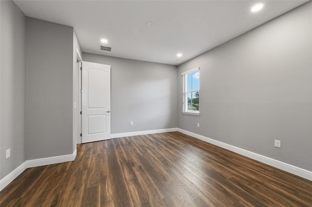 unfurnished room with dark hardwood / wood-style floors