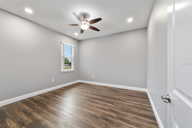 empty room with ceiling fan and dark wood-type flooring