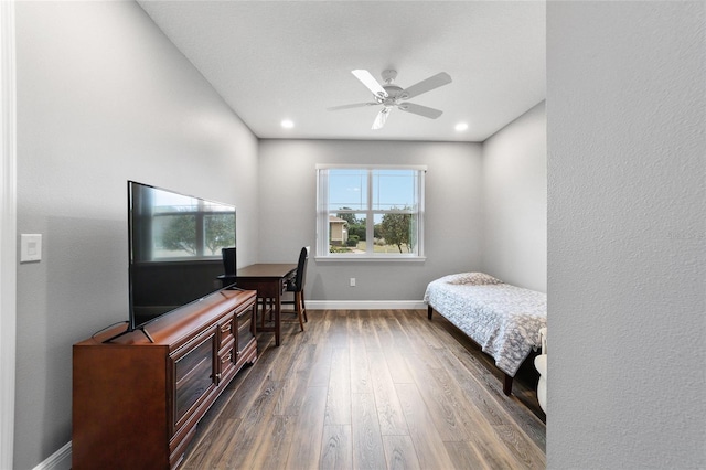 bedroom with ceiling fan and dark hardwood / wood-style flooring