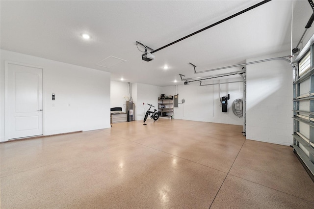 garage featuring a garage door opener and water heater