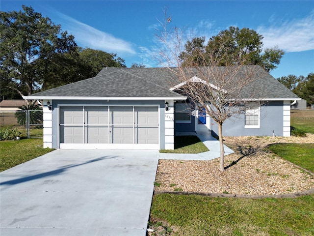 single story home featuring a garage and a front lawn