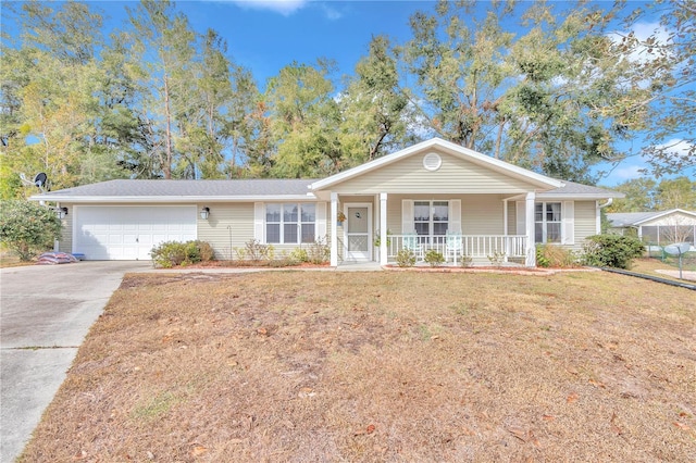 ranch-style house featuring a front yard, covered porch, and a garage