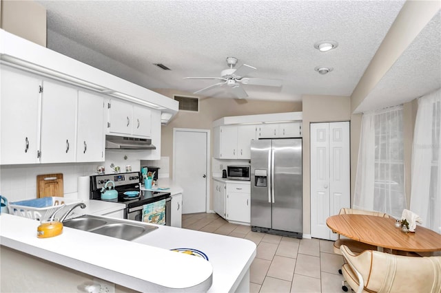 kitchen with light tile patterned floors, kitchen peninsula, appliances with stainless steel finishes, white cabinets, and sink