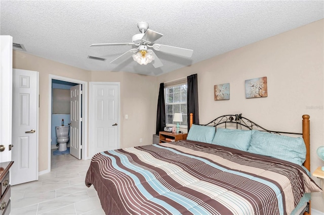 bedroom with a textured ceiling, ceiling fan, and ensuite bathroom