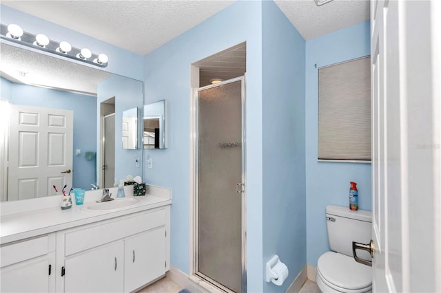 bathroom with vanity, toilet, a textured ceiling, and an enclosed shower