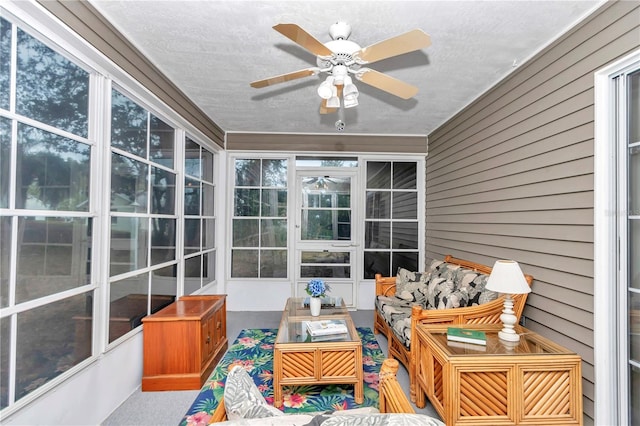 sunroom featuring ceiling fan