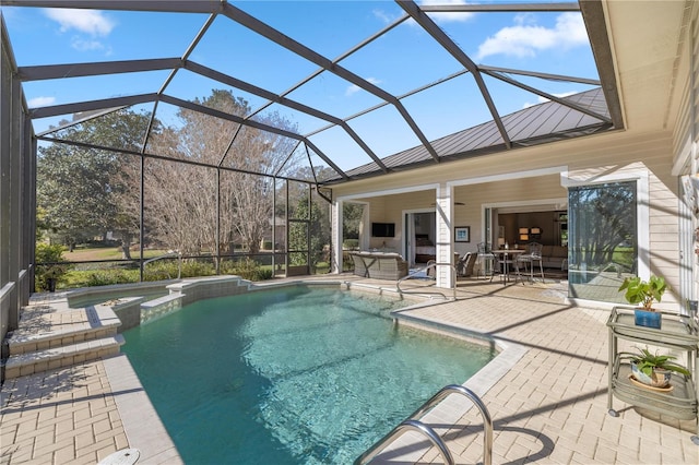 view of pool featuring a lanai, a patio area, and an in ground hot tub