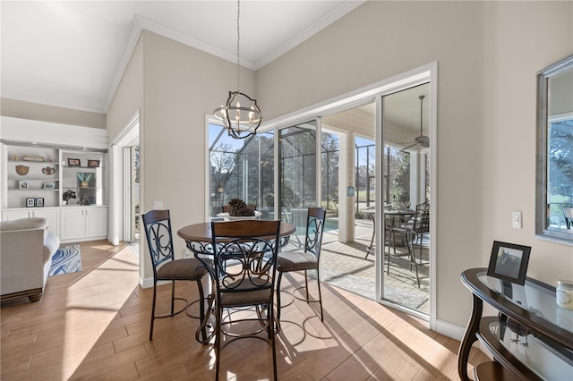 dining room with crown molding and a chandelier