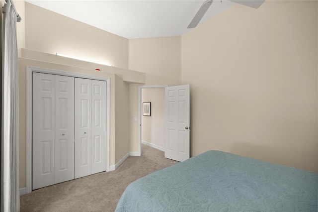 carpeted bedroom featuring ceiling fan and a closet