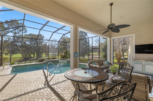 sunroom with ceiling fan, sink, and a pool