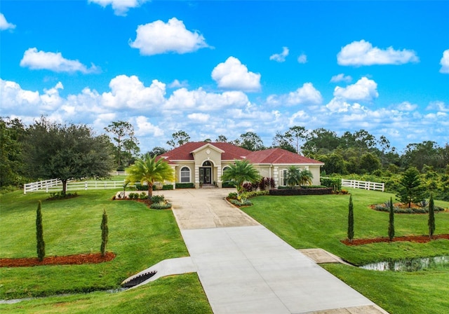 mediterranean / spanish-style home featuring a front lawn