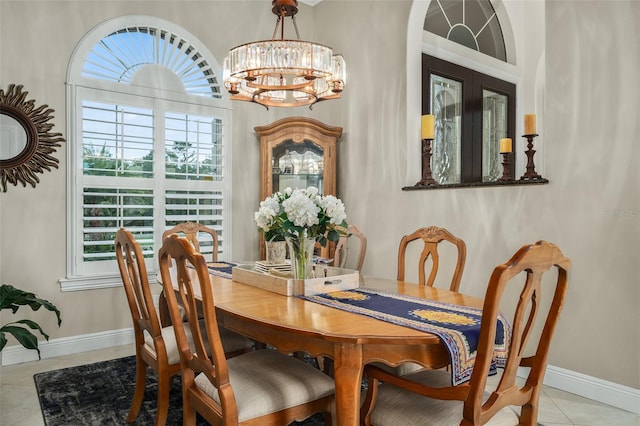 tiled dining space featuring a notable chandelier