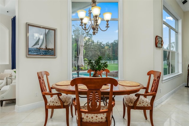 dining space featuring a notable chandelier, a healthy amount of sunlight, light tile patterned floors, and crown molding