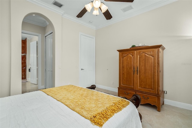 tiled bedroom with ceiling fan and ornamental molding