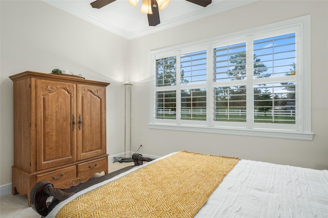 bedroom with ceiling fan and ornamental molding