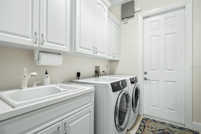 washroom featuring washer and clothes dryer, cabinets, and sink