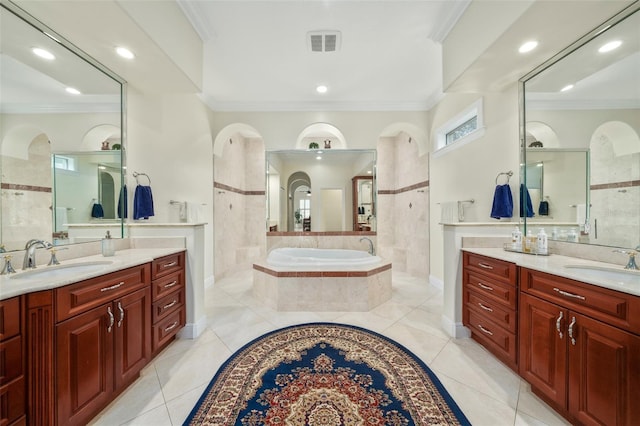 bathroom featuring tile patterned floors, vanity, crown molding, and tiled bath