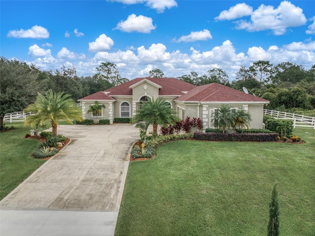 mediterranean / spanish-style home with a front lawn