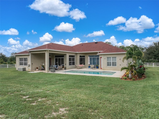 back of house featuring a yard and a patio