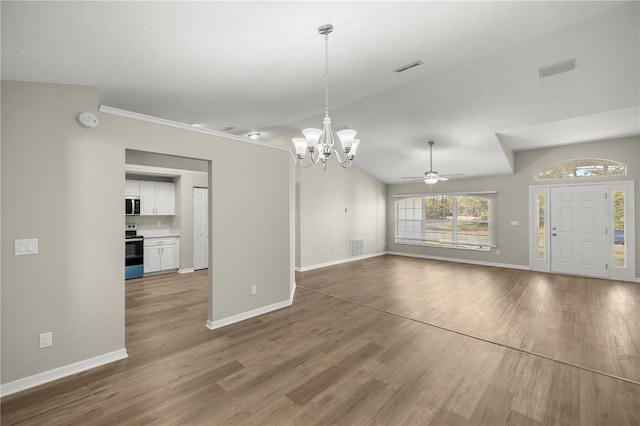 interior space with hardwood / wood-style flooring, ceiling fan with notable chandelier, and vaulted ceiling