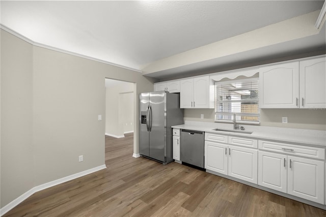 kitchen with light wood-type flooring, white cabinetry, sink, and appliances with stainless steel finishes