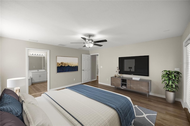 bedroom with connected bathroom, ceiling fan, and dark wood-type flooring