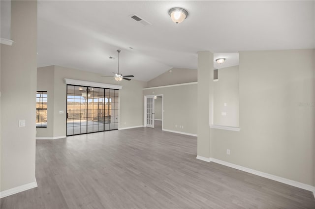 unfurnished living room with ceiling fan, lofted ceiling, and light wood-type flooring