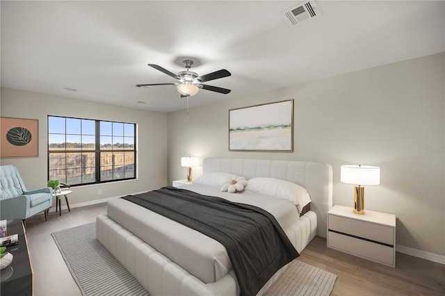 bedroom with ceiling fan and light wood-type flooring